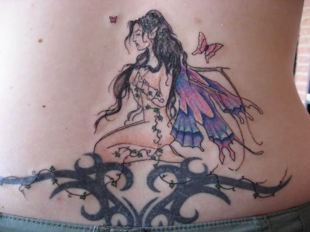  Sad Angle Sitting Desperately Reflected in A Creative Tribal Tattoo Design in the Lower Back of Sexy Girl